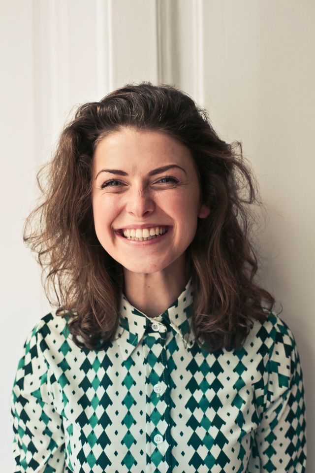 A smiling young woman with curly hair
